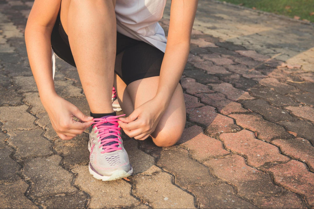 Person Tying Running Shoe