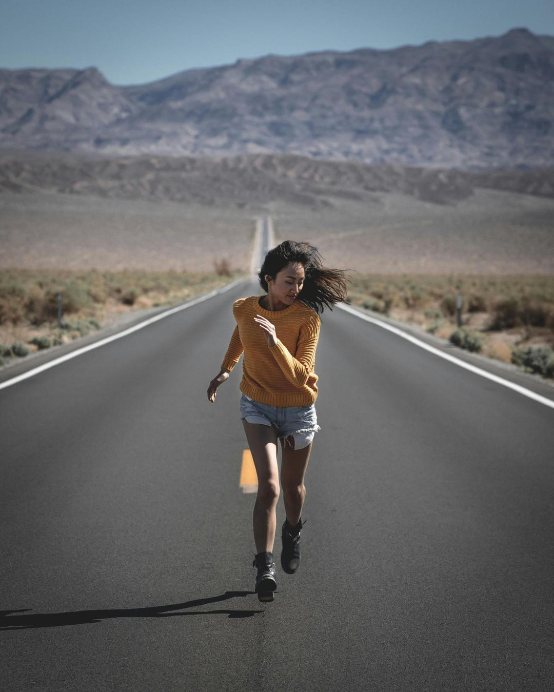 Woman Running on Empty Road